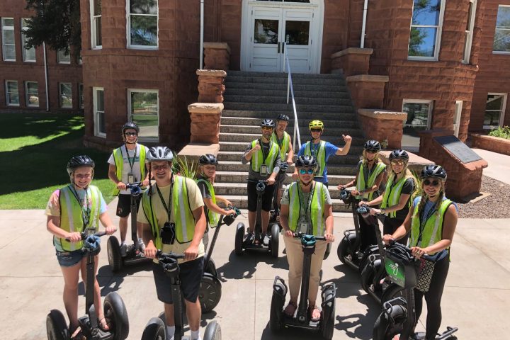 a group of people riding on the back of a bicycle